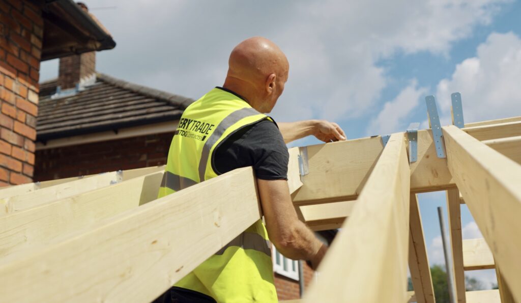 A picture of an EveryTrade worker in a high-vis working on a new roof