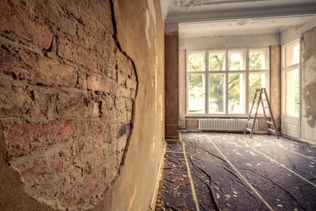 close up of a room under construction with a brick wall partially visible